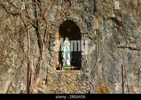 Statue of Virgin Mary in a recess carved into natural rock near Bohinjska Bela Stock Photo