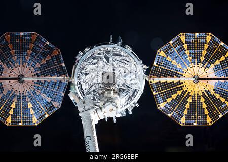 The Cygnus cargo spacecraft in the grips of the Canadarm2 robotic arm. Stock Photo