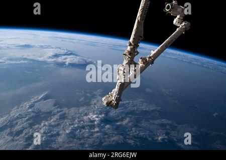 The Canadarm2 robotic arm as the International Space Station orbits over Mongolia. Stock Photo