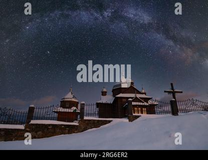 Night sky mith milkyway srars above countryside remote village church