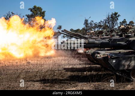 An armored crew from Comanche Company, 4th Battalion, 6th infantry Regiment, fires an M1A2 Abrams tank during a Live Fire Accuracy Screening Test at the Townsville Field Training Area in Queensland, Australia, August 4, 2023. Comanche Company and the Australian Army’s 2nd Calvary Regiment are preparing to participate in a combined arms live fire exercise. Stock Photo