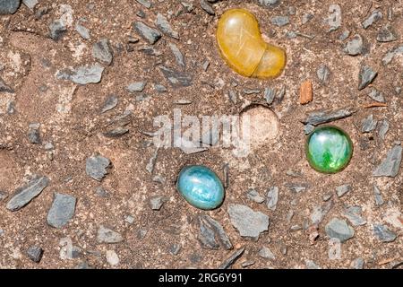Colored stones embedded in concrete walkway Stock Photo