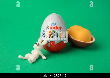 Slynchev Bryag, Bulgaria - May 25, 2023: Kinder Surprise Eggs, plastic capsule and toy bunny on green background Stock Photo
