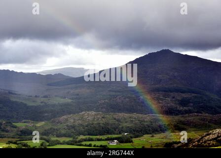 Duddon Valley, Cumbria, UK, 7th August 2023. Rainbow over the upper reaches of the Duddon Valley, Lake District National Park, Cumbria, UK. mountains, fells, walk walking , ramble rambling, lakes, cumbrian. Credit: Terry Waller/Alamy Live News Stock Photo