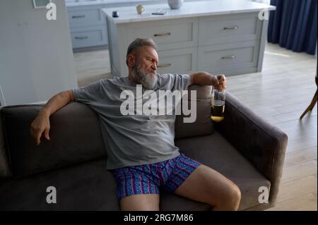 Drunk senior man looking at camera with angry rage emotion on face Stock Photo