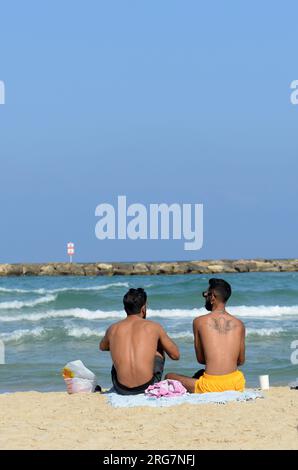 Guys chillin on the beach in Tel-Aviv, Israel. Stock Photo