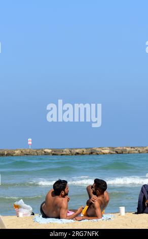 Guys chillin on the beach in Tel-Aviv, Israel. Stock Photo