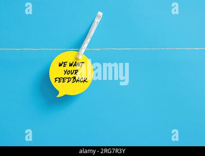 We want your feedback message on a speech bubble hanging on clothesline with a clothespin. Customer evaluation or satisfaction. Business services or p Stock Photo