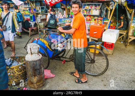 New Delhi, India - October 16, 2010: indian rickshaw driver looks for passengers in the old part of New Delhi. The rickshaws are registered by New Del Stock Photo