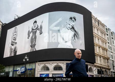 London, UK.  8 August 2023. Photographic artist Ray Burmiston at the launch of ‘Art of London Presents Take A Moment 2023’, his new photography exhibition featuring hundreds of famous faces with their eyes closed for mental health awareness.  Faces are seen on the big screens at Piccadilly Circus, ahead of an exhibition in the National Portrait Gallery in September.  Members of the public can also send a selfie and be part of the art alongside their favourite stars on the Piccadilly Circus screens and in the National Portrait Gallery..  Credit: Stephen Chung / Alamy Live News Stock Photo