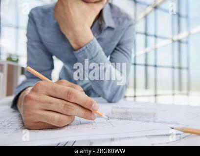 Architect engineer contractor design working drawing sketch plan blueprint and making architectural construction house building in architect studio. Stock Photo