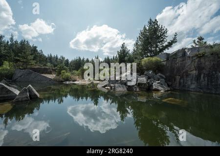 Reflections in the calm waters that fill an abandoned quarry near Lugo Galicia Stock Photo