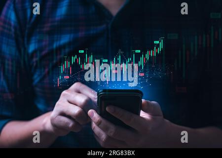 Business man or trader showing a virtual trading chart on a smartphone. planning and strategy, Stock market, Business growth, progress or success conc Stock Photo