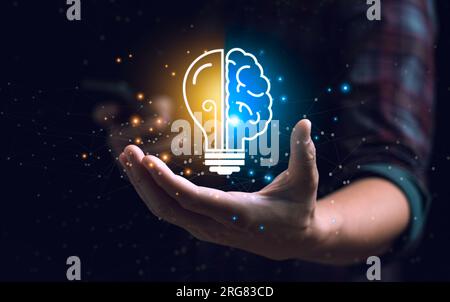 Smart thinking idea and inspiration innovation concept. businessman holding half brain icon and light bulb. Solve problems intelligently Stock Photo