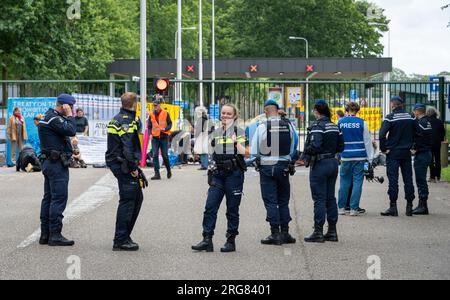 Volkel, The Netherlands, 07.08.2023, Dutch police officers at Volkel military air base during the protest of peace activists against nuclear weapons Stock Photo