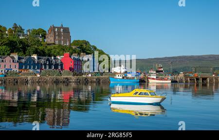 Beautiful town of Tobermory, Isle of Mull, Scotland with colourful houses and still water in the sunshine Stock Photo