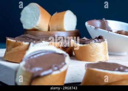 Chocolate butter spread on bread while cooking breakfast, making breakfast from wheat bread with bran and chocolate butter Stock Photo