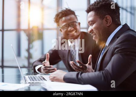 African american boss negotiating discussing contract details with company corporate client. Stock Photo