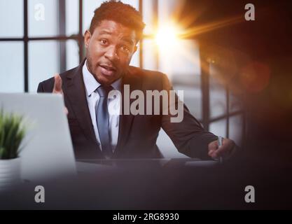 Focused young businessman signing agreement with skilled lawyer Stock Photo