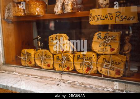 Pisa, Italy - March 18, 2023:Panforte in festive paper packaging for sale on the counter of a shop window. High quality photo Stock Photo