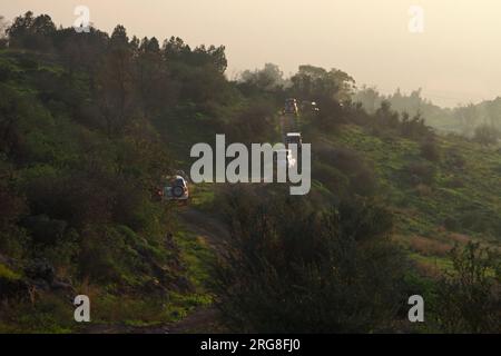 a convoy of Off road Vehicles negotiating a climb Golan Heights, Israel Stock Photo