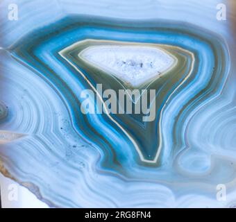 Thin slice of blue Agate with crystals in a geode, , lit from behind Stock Photo