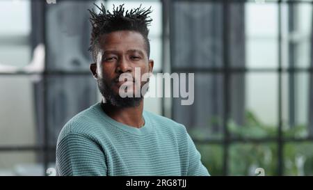 Thoughtful young black man looking straight ahead Stock Photo