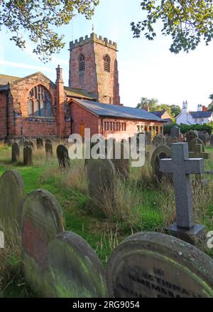 Overgrown graveyard of St Wilfrids historic parish church in the evening, Church Lane, Grappenhall village, Warrington, Cheshire, England, WA4 3EP Stock Photo