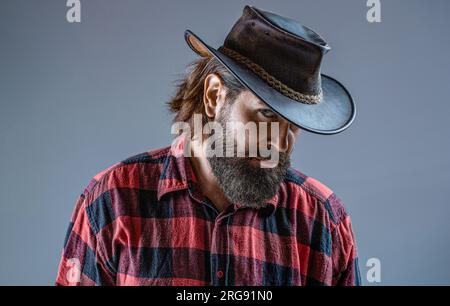 Handsome hipster with cowboy hat. Leather cowboy hat. Portrait man wearing cowboy hat. Cowboys in hat. Handsome bearded macho. Man unshaven cowboys Stock Photo