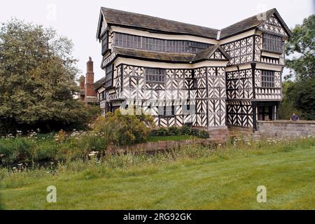 View of Little Moreton Hall, near Congleton in Cheshire, a moated 15th century half-timbered manor house.  It is a Grade I listed building, open to the public for part of the year, and popular as a film and TV location. Stock Photo