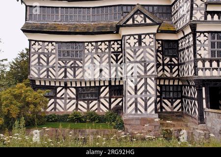 A close-up view of Little Moreton Hall, near Congleton in Cheshire, a moated 15th century half-timbered manor house.  It is a Grade I listed building, open to the public for part of the year, and popular as a film and TV location. Stock Photo