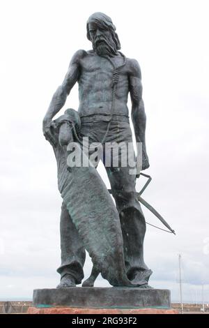 Statue of the Ancient Mariner at Watchet, Somerset, unveiled in September 2003 as a tribute to the 19th century poet Samuel Taylor Coleridge who lived in the nearby village of Nether Stowey.  T sight of Watchet harbour inspired him to write his long narrative poem, The Rime of the Ancient Mariner:  'Ah ! well a-day ! / what evil looks / Had I from old and young ! / Instead of the cross, the Albatross / About my neck was hung.' Stock Photo