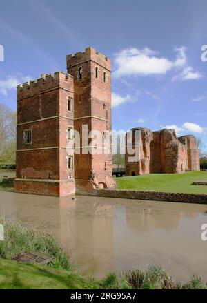 View of Kirby Muxloe Castle, Leicestershire, an unfinished 15th century fortified manor house.  Showing a rather muddy-looking moat in the foreground. Stock Photo