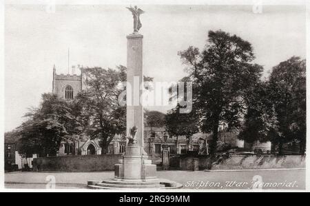 War Memorial, High Street, Skipton, North Yorkshire, with the Church of the Holy Trinity in the background. Stock Photo