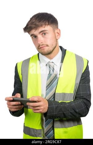 Portrait of a business man in a suit, with a hi-vis vest reading messages on a mobile phone Stock Photo