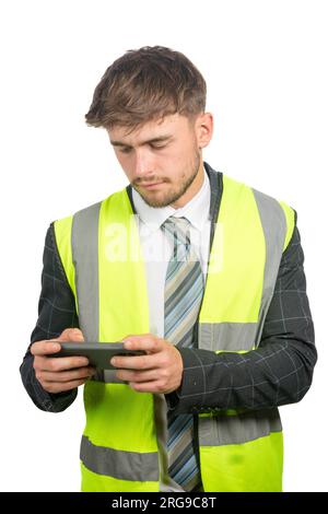 Portrait of a business man in a suit, with a hi-vis vest reading messages on a mobile phone Stock Photo