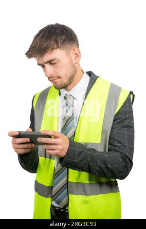 Portrait of a business man in a suit, with a hi-vis vest reading messages on a mobile phone Stock Photo