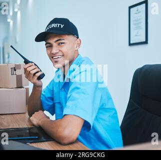 Walkie talkie, security guard and man in portrait in office in conversation and communication. Safety, face and happy officer on radio at table to Stock Photo