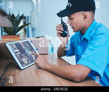 Security guard, walkie talkie and man on tablet in surveillance, cctv system and smart monitor. Technology, camera and serious officer on radio at Stock Photo