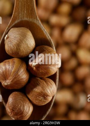 Peeled hazelnuts. Hazelnut kernels lie in wooden spoon. Top view of nuts close-up. Advertising photography for marketplaces or online stores. Stock Photo