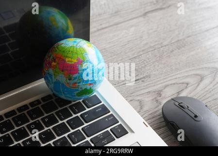 Close up image of globe, laptop keyboard and computer mouse. Internet, globalization and technology concept Stock Photo