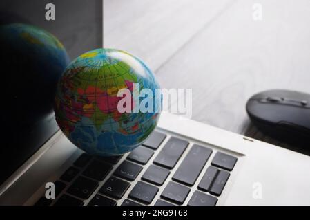 Close up image of globe, laptop keyboard and computer mouse. Internet, globalization and technology concept Stock Photo