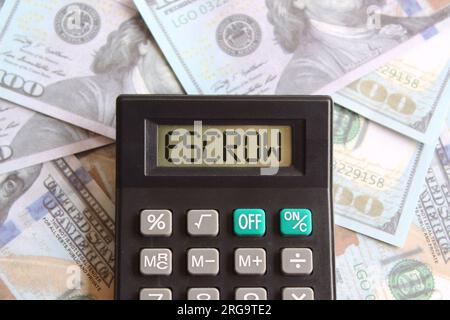 Top view image of money and calculator with text ESCROW on display. Finance concept. Stock Photo