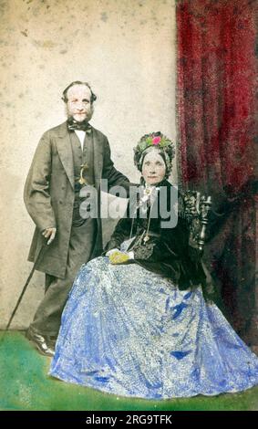 A hand-tinted Victorian studio carte de visite (CdV) photograph of a fine middle class couple Stock Photo