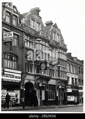 Photograph of Angel PH, Ilford (Old), Essex. The main side of the print (shown here) depicts: Left Face on view of the pub.  The back of the print (available on request) details: Photographer ID for the Angel, Ilford (Old), Essex IG1 1DE. As of July 2018 . Old building now Bonmarche Stock Photo