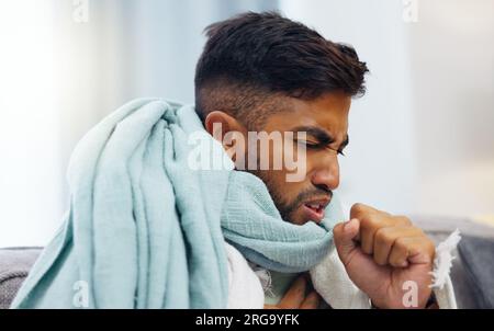 Sick, cough and healthcare with Indian man on sofa for influenza, illness and pain. Problem, medical and virus infection with guy suffering in living Stock Photo