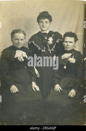 Three women, probably from the same family, all in black, possibly in mourning. Stock Photo