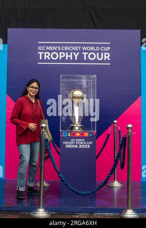 Dhaka, Bangladesh. 08th Aug, 2023. A sports journalist poses for a photo next to the ICC Men's Cricket World Cup trophy on display at the Sher-e-Bangla National Stadium in Mirpur, Dhaka. ICC Men's Cricket World Cup trophy tour in Bangladesh runs from 07 till 09 August 2023. Credit: SOPA Images Limited/Alamy Live News Stock Photo