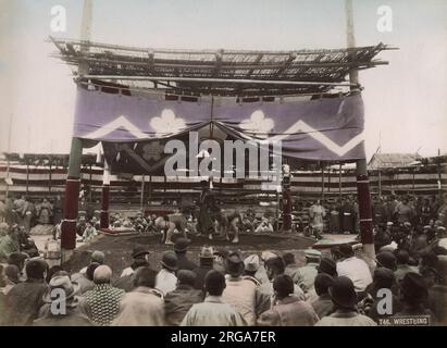Large crowd watching sumo wrestling in an outdoor arena. Vintage 19th century photograph. Stock Photo