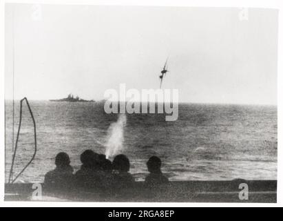 Vintage World War II photograph - Japanese suicide kamikaze attack on an American battleship in the Pacific. The plane was brought down just short of the ship. Stock Photo